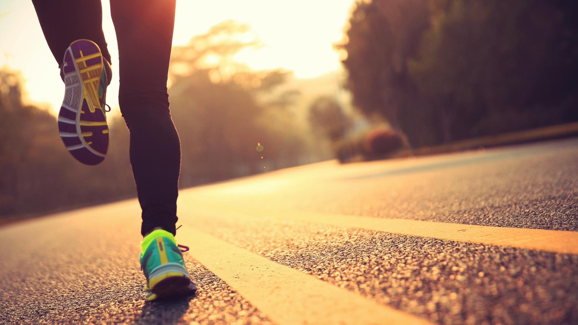 View of a persons legs running on a track